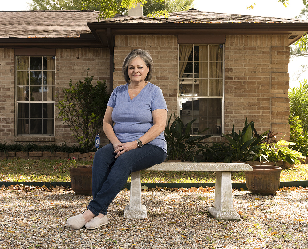 Marilyn and partner in front of their Texas home