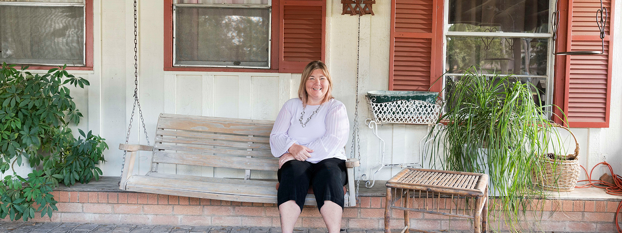 Rachel Smith standing in front of her Texas home